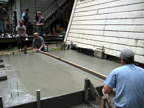 Screeding the wet concrete to a perfect level. -- 